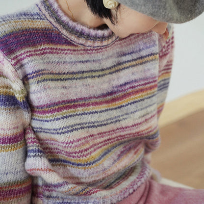 Blurred rainbow-colored knit sweater and scarf