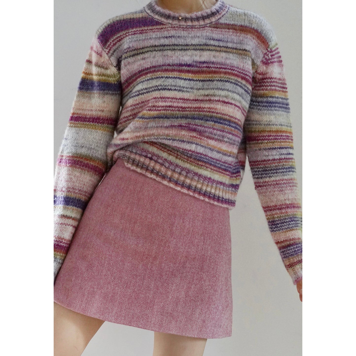 Blurred rainbow-colored knit sweater and scarf