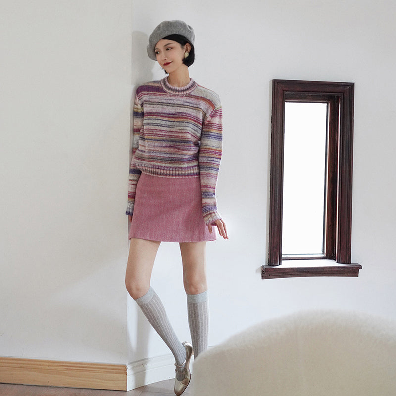 Blurred rainbow-colored knit sweater and scarf