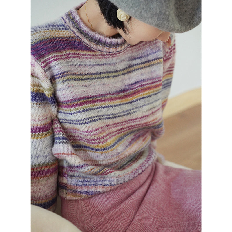 Blurred rainbow-colored knit sweater and scarf