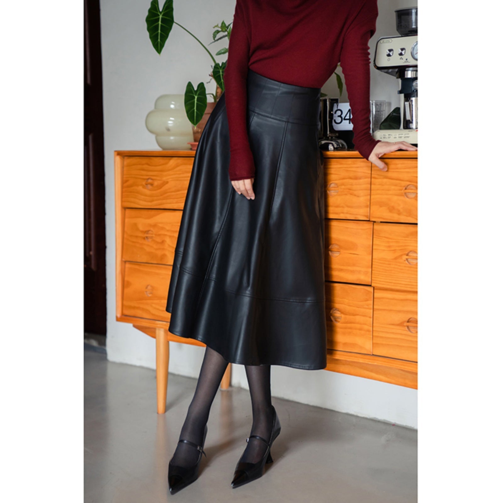 Jet-black lady's high-waisted leather skirt