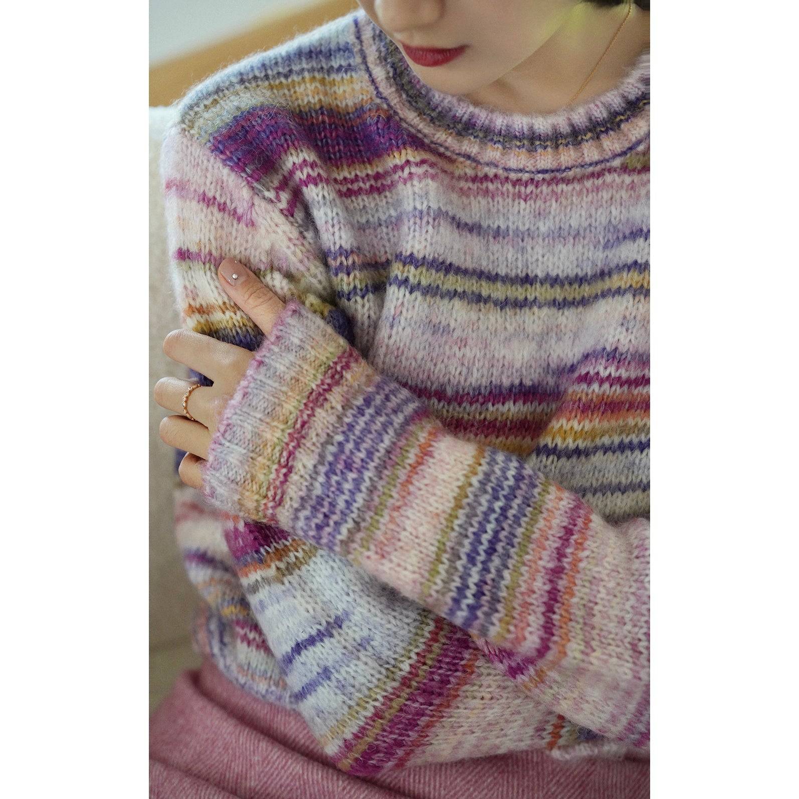 Blurred rainbow-colored knit sweater and scarf