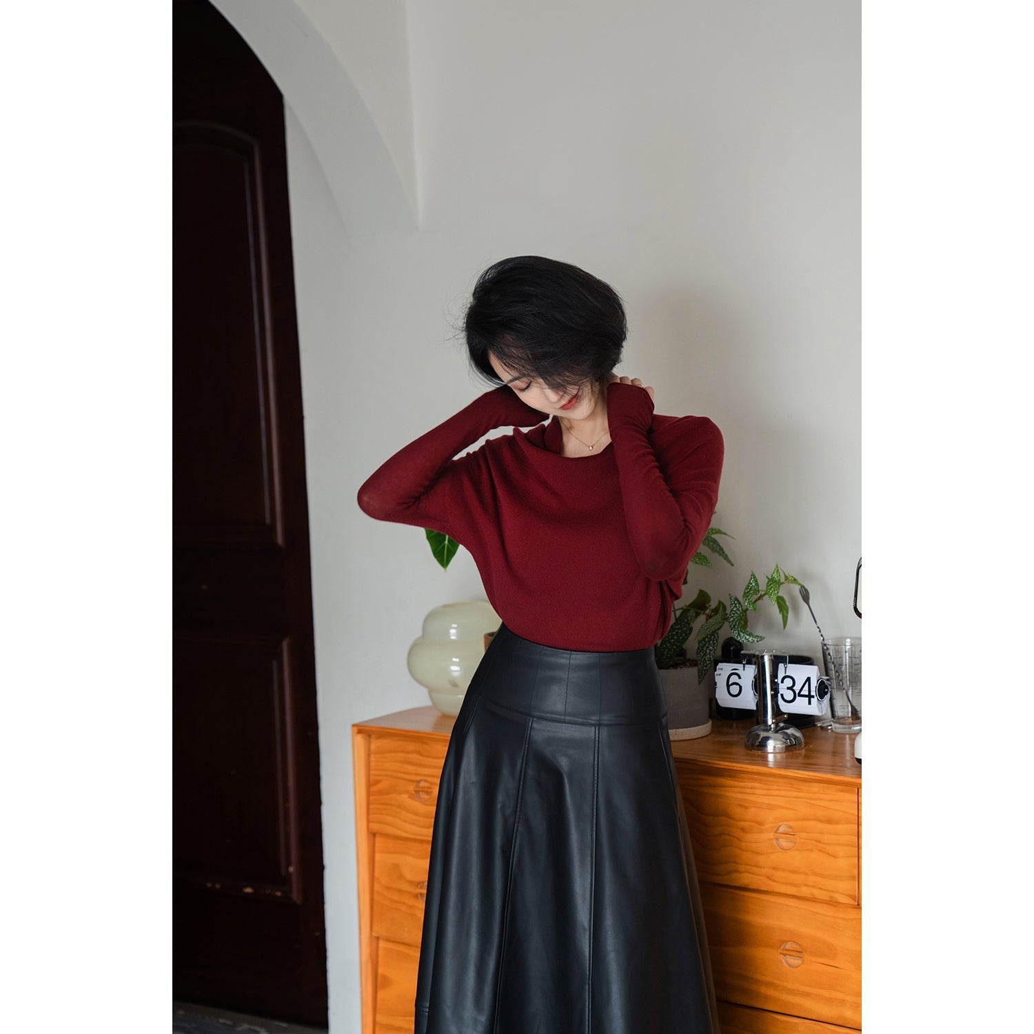 Jet-black lady's high-waisted leather skirt