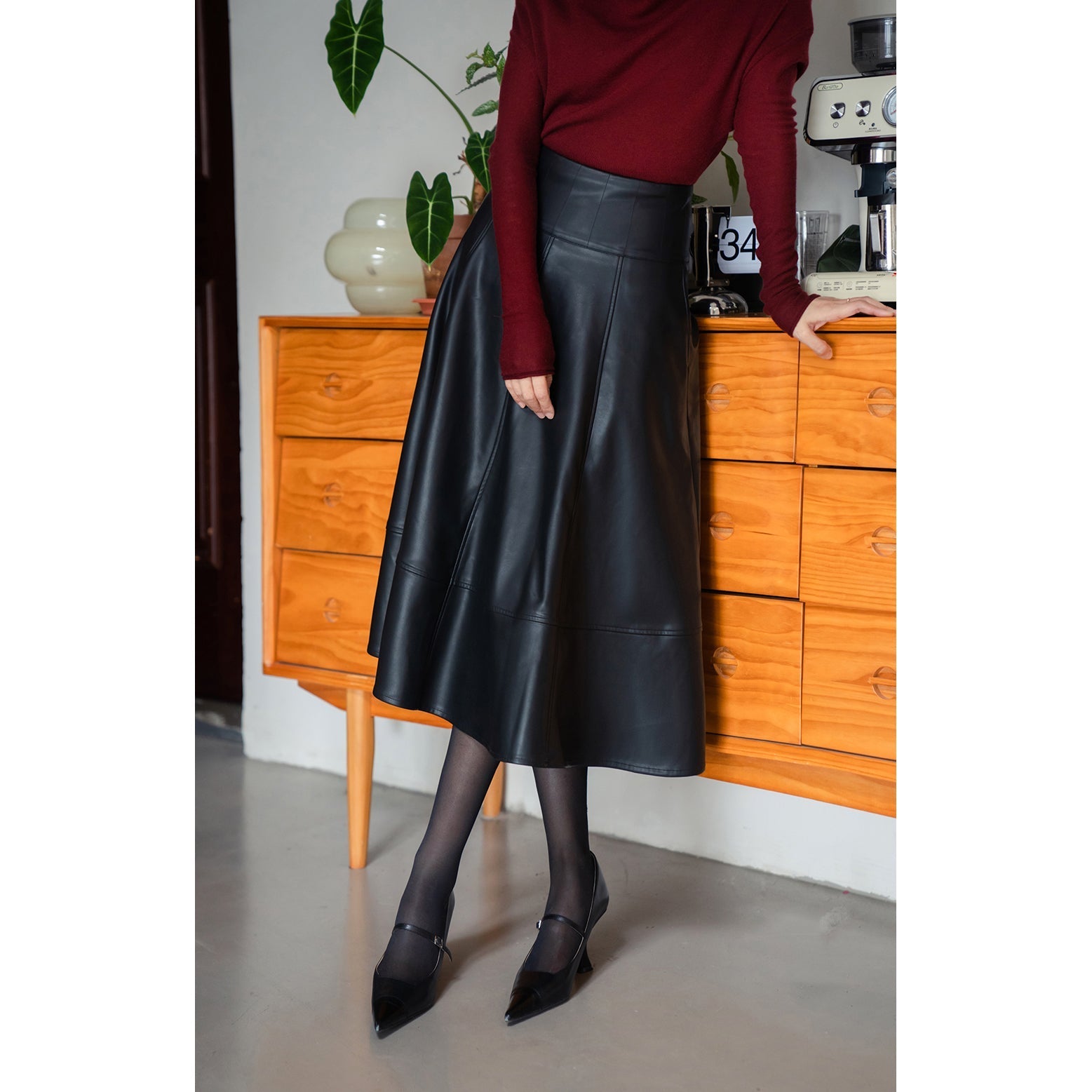 Jet-black lady's high-waisted leather skirt