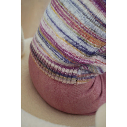 Blurred rainbow-colored knit sweater and scarf