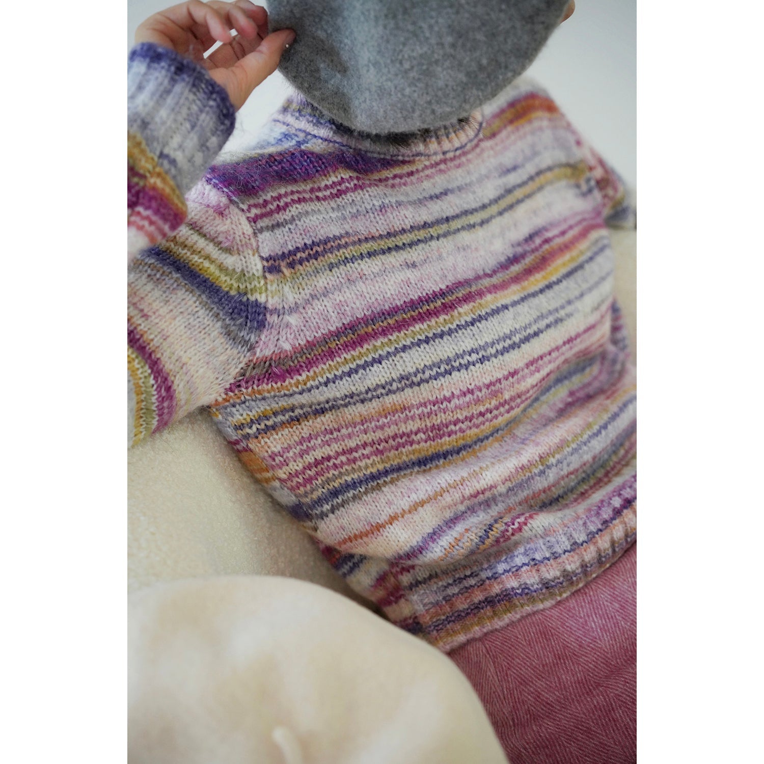 Blurred rainbow-colored knit sweater and scarf