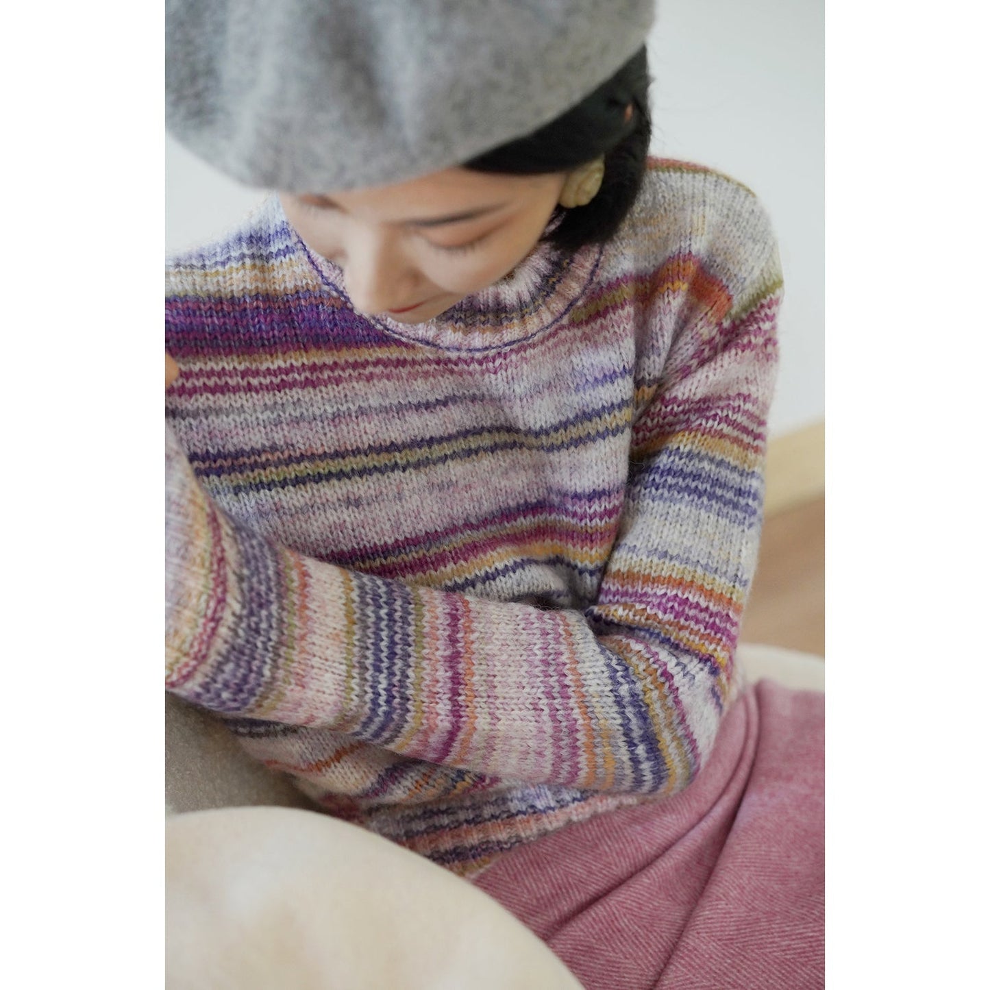 Blurred rainbow-colored knit sweater and scarf