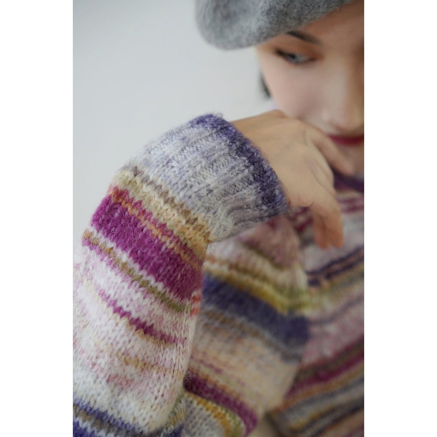 Blurred rainbow-colored knit sweater and scarf