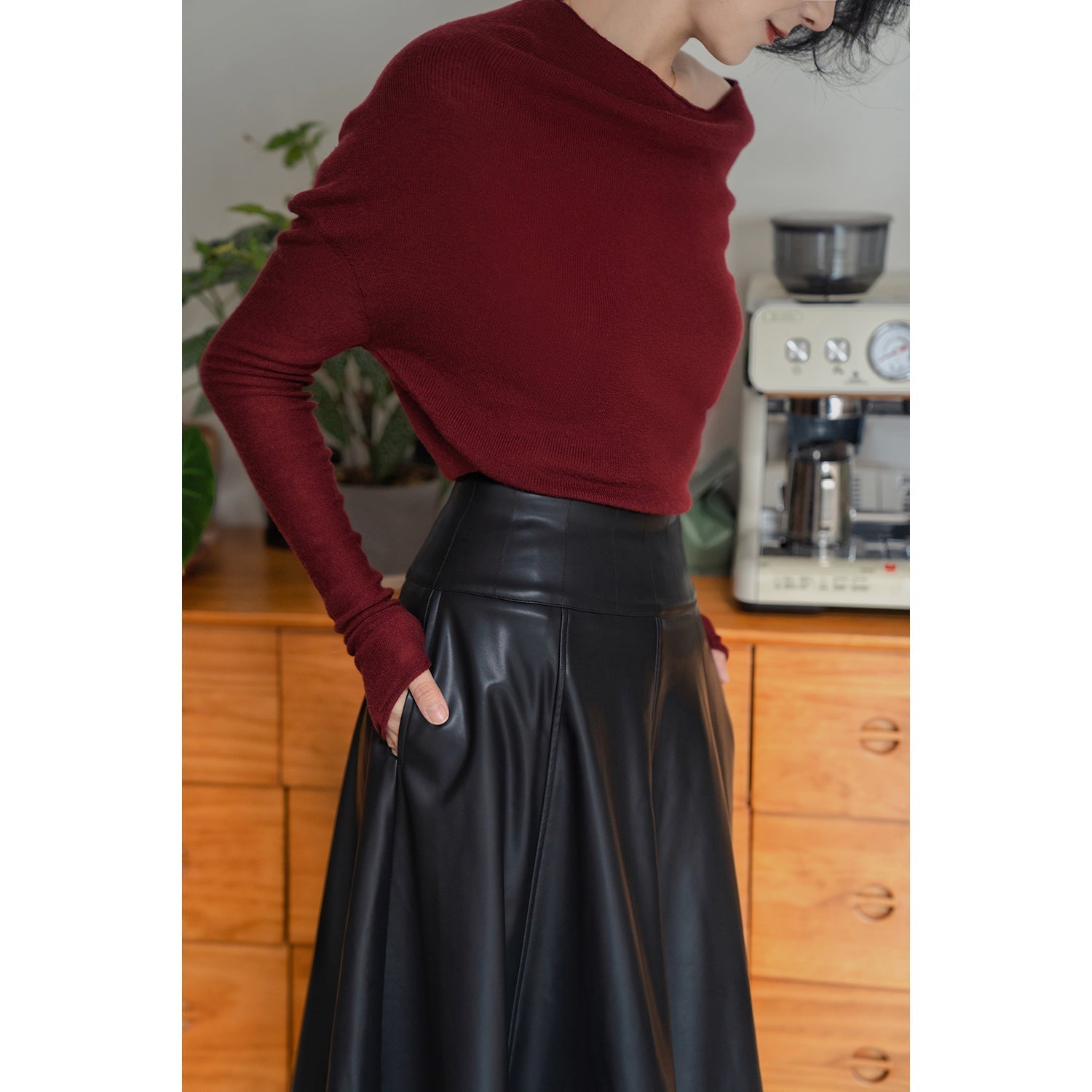 Jet-black lady's high-waisted leather skirt