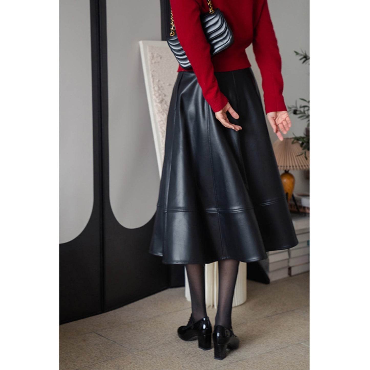 Jet-black lady's high-waisted leather skirt