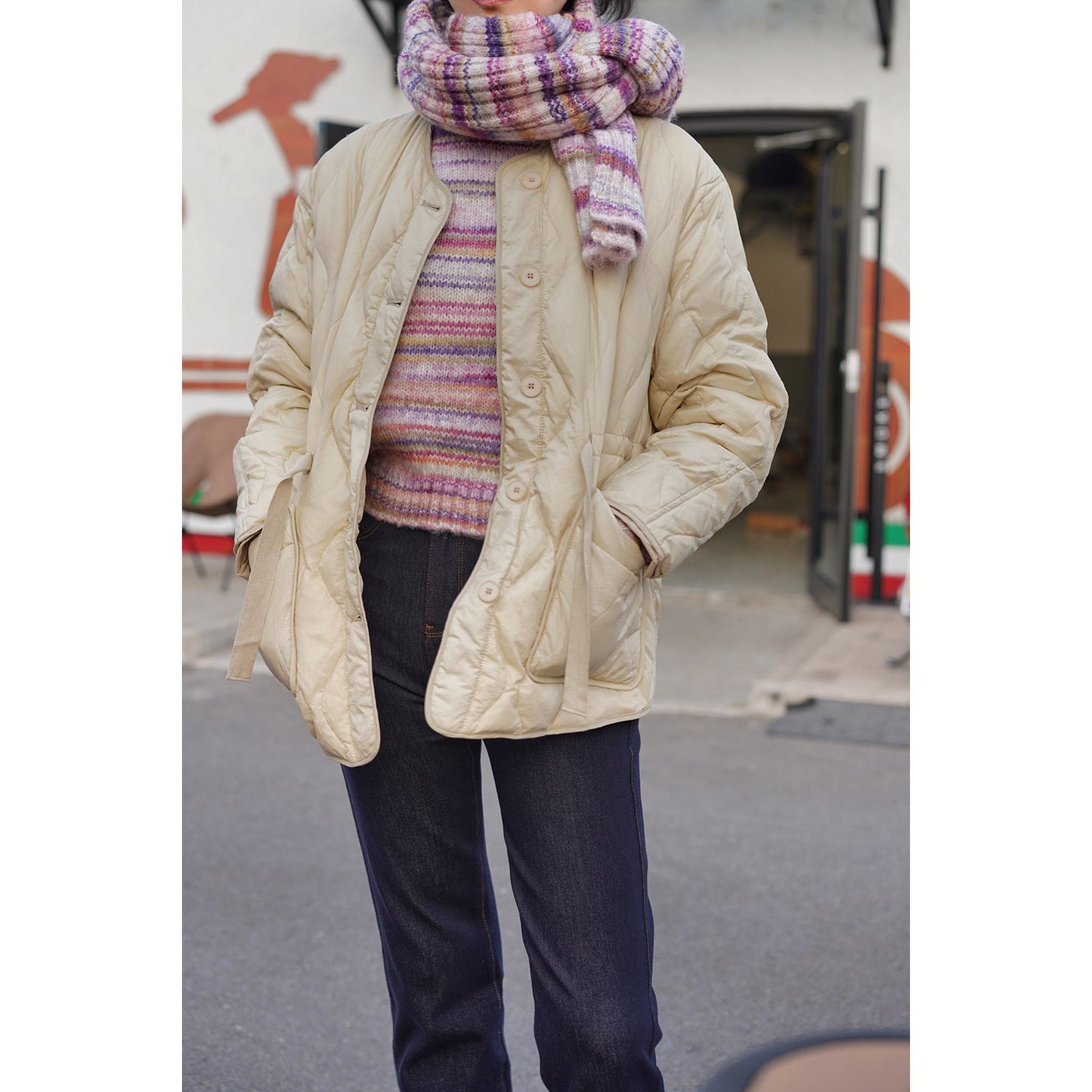 Blurred rainbow-colored knit sweater and scarf