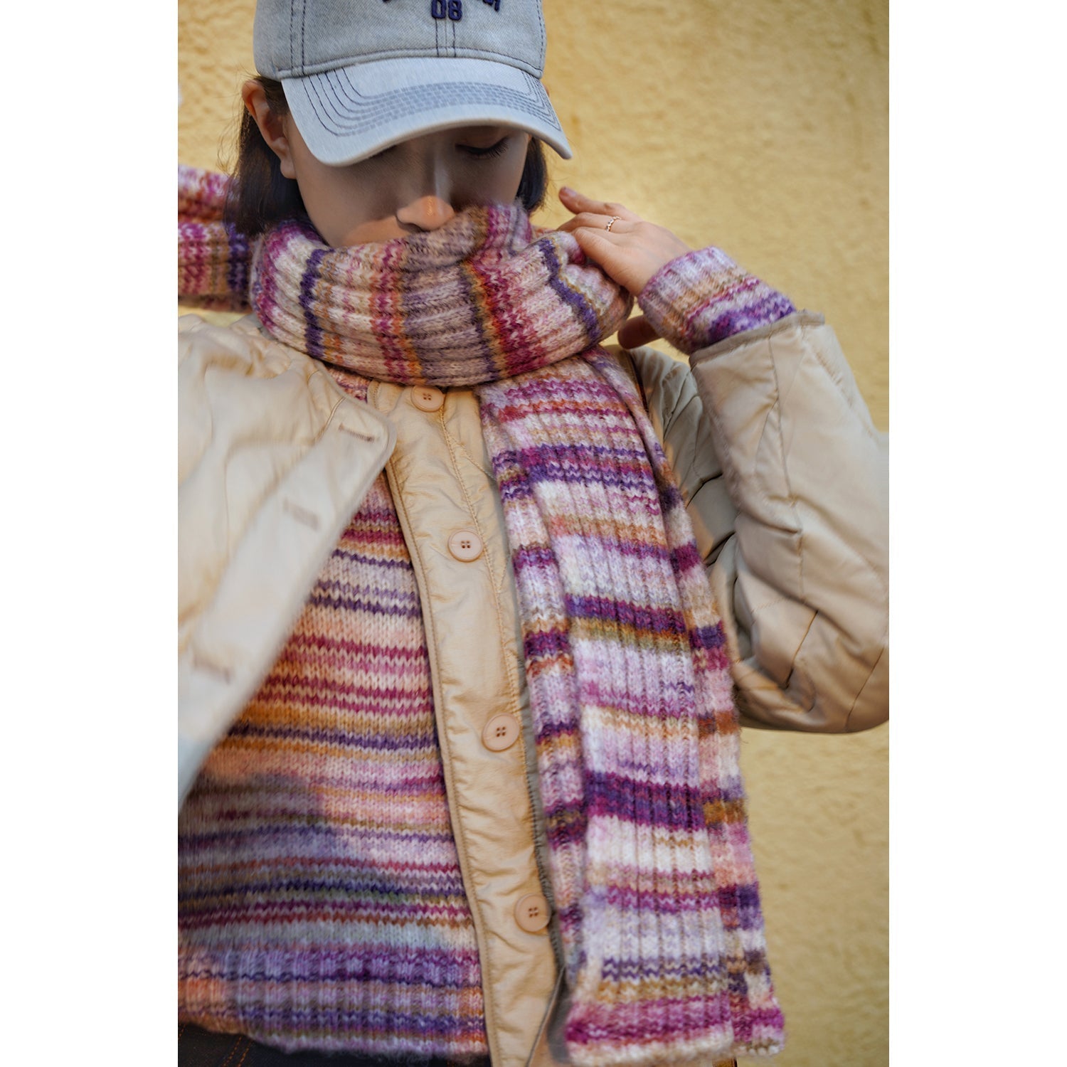 Blurred rainbow-colored knit sweater and scarf