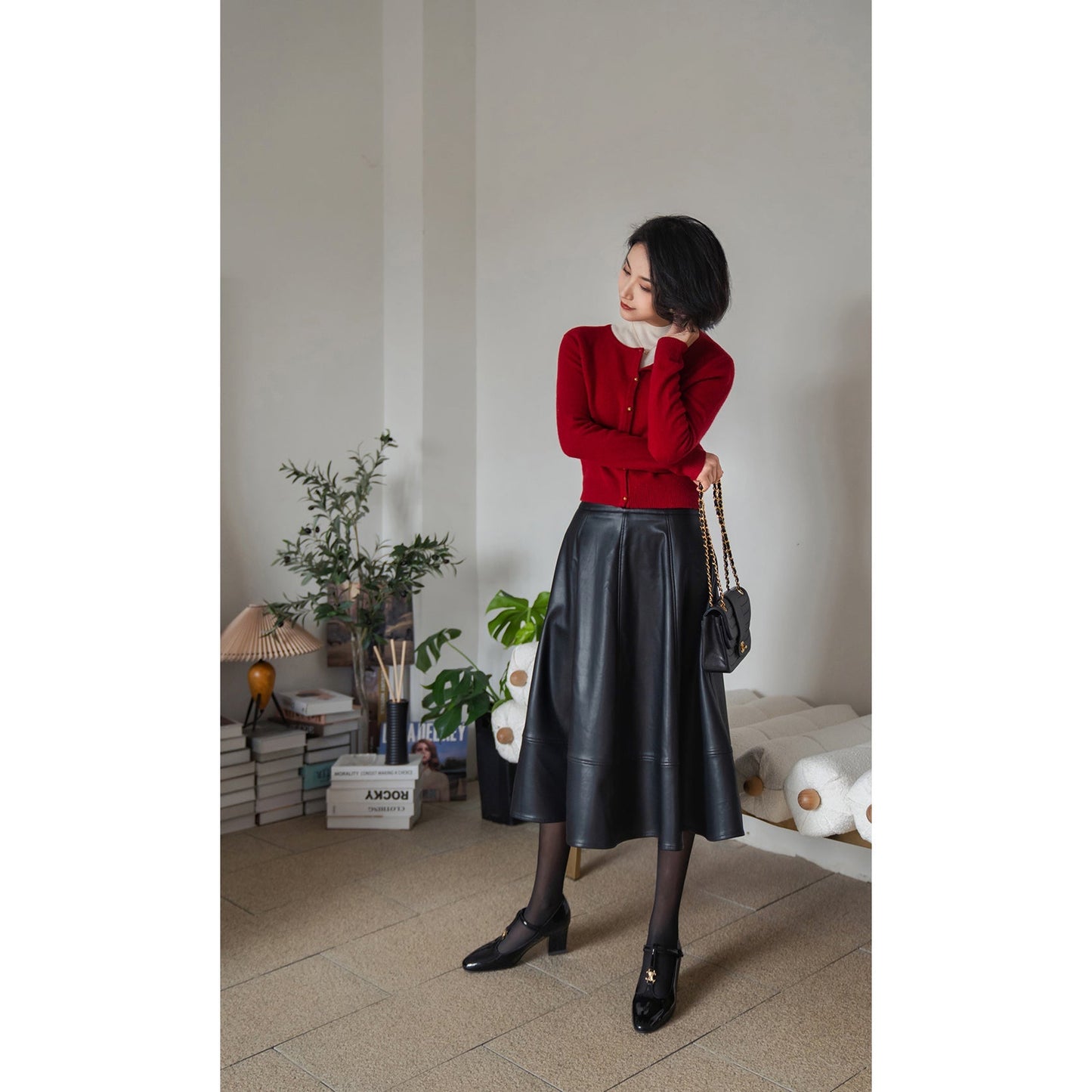 Jet-black lady's high-waisted leather skirt