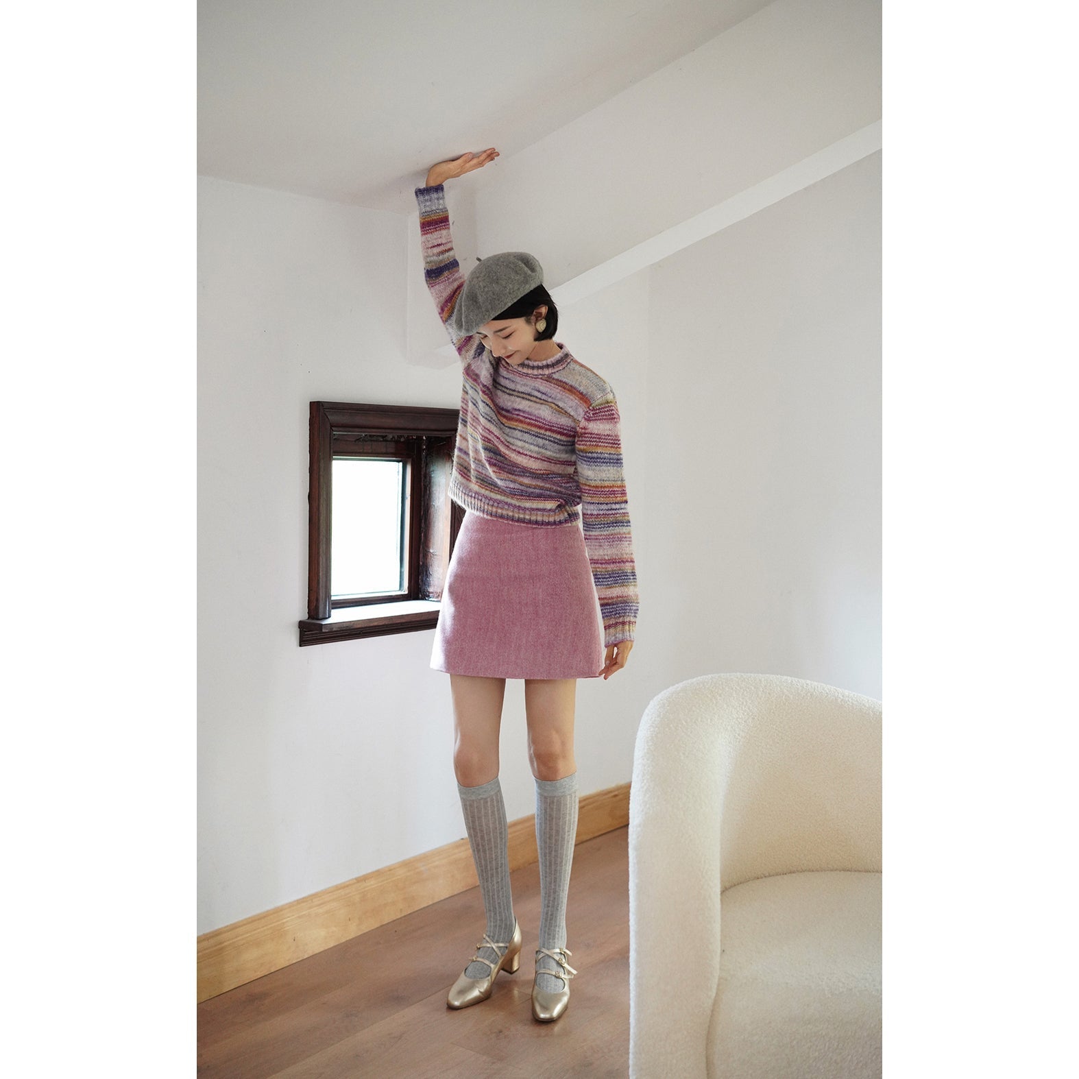 Blurred rainbow-colored knit sweater and scarf