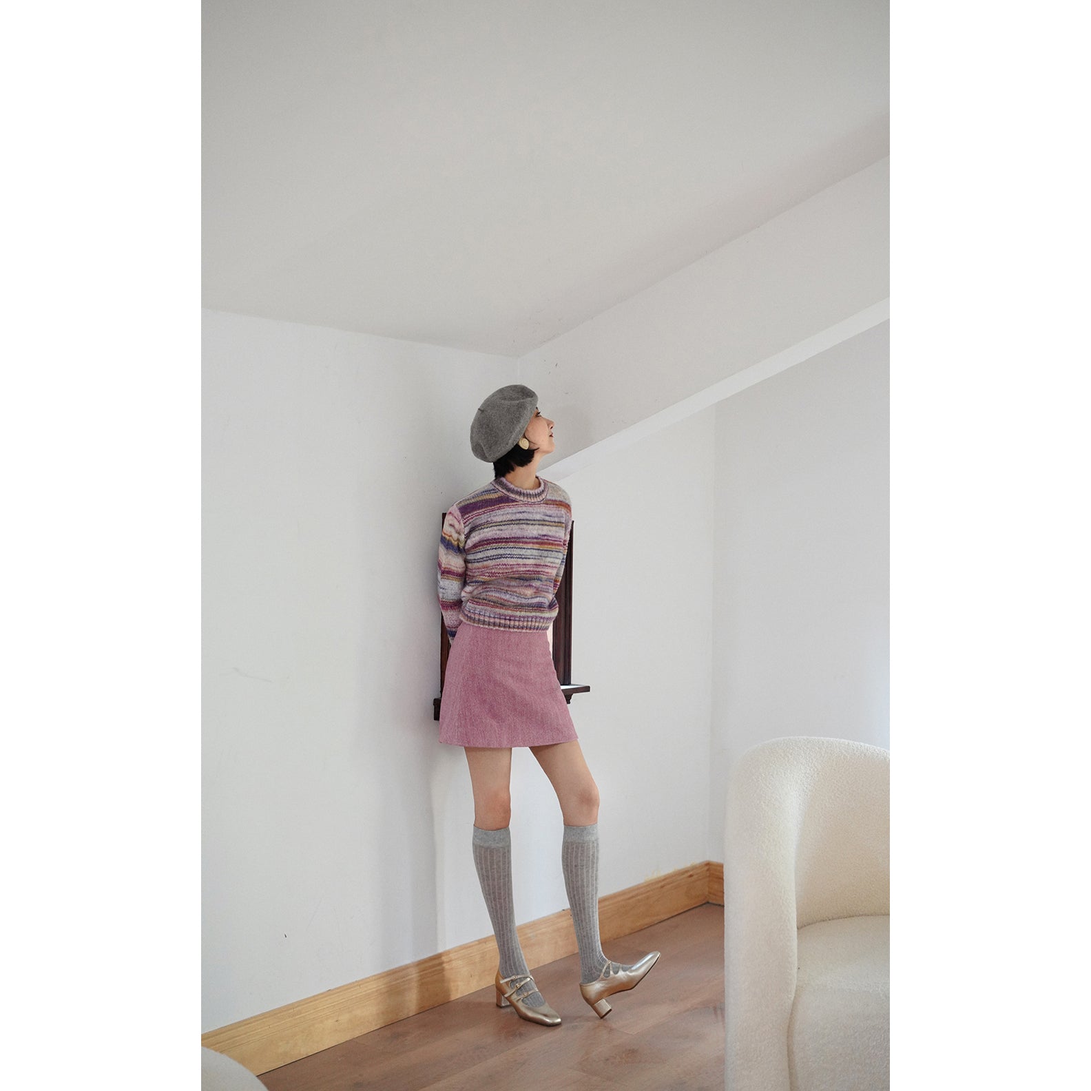 Blurred rainbow-colored knit sweater and scarf