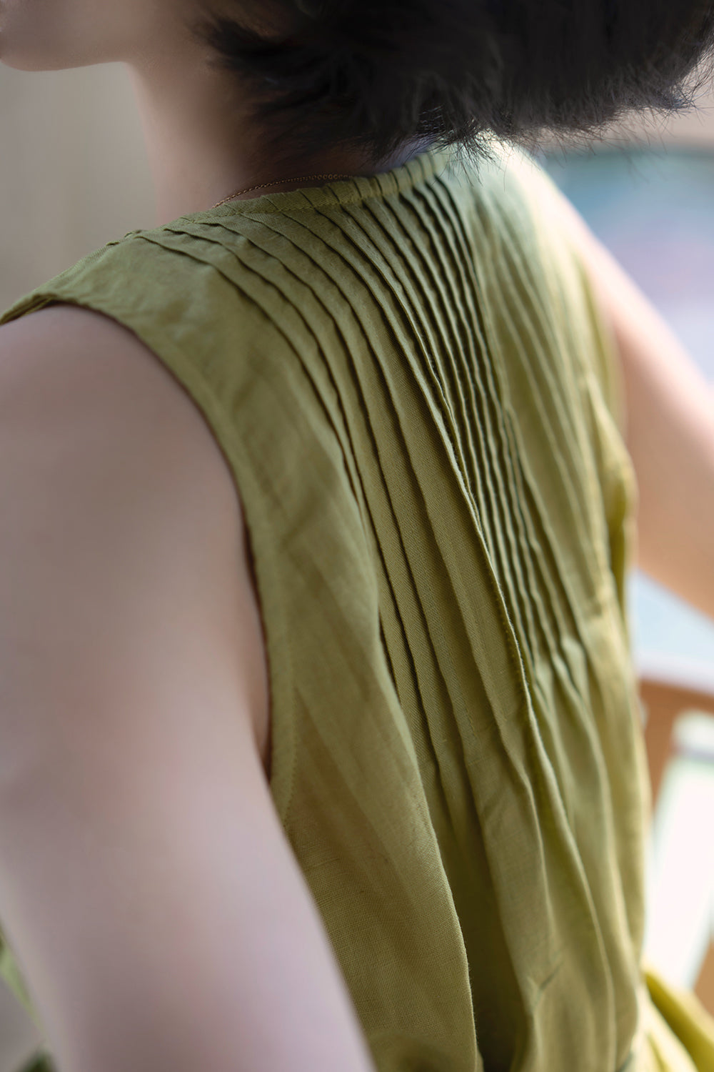 Light green sleeveless pleated top