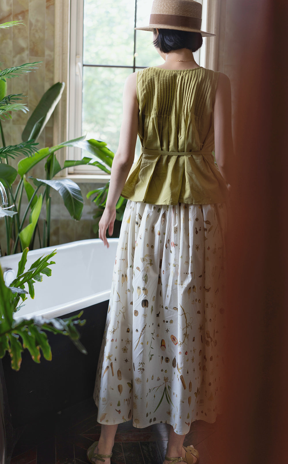 Light green sleeveless pleated top