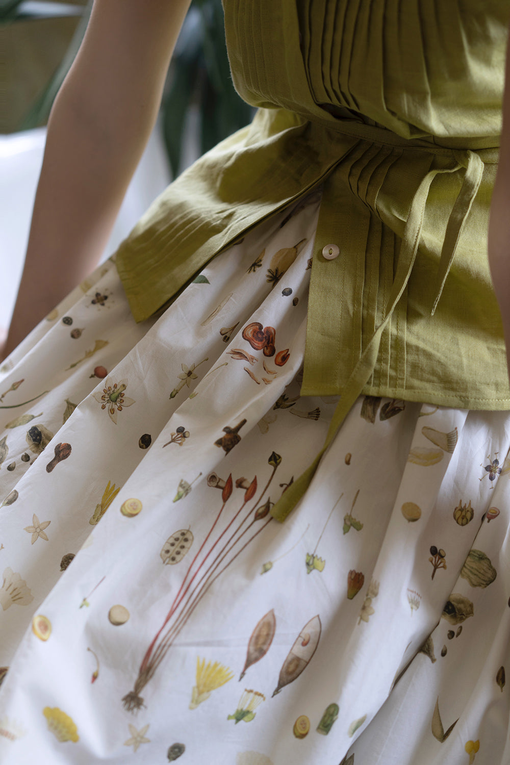 Light green sleeveless pleated top