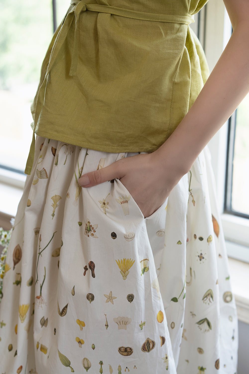 Light green sleeveless pleated top